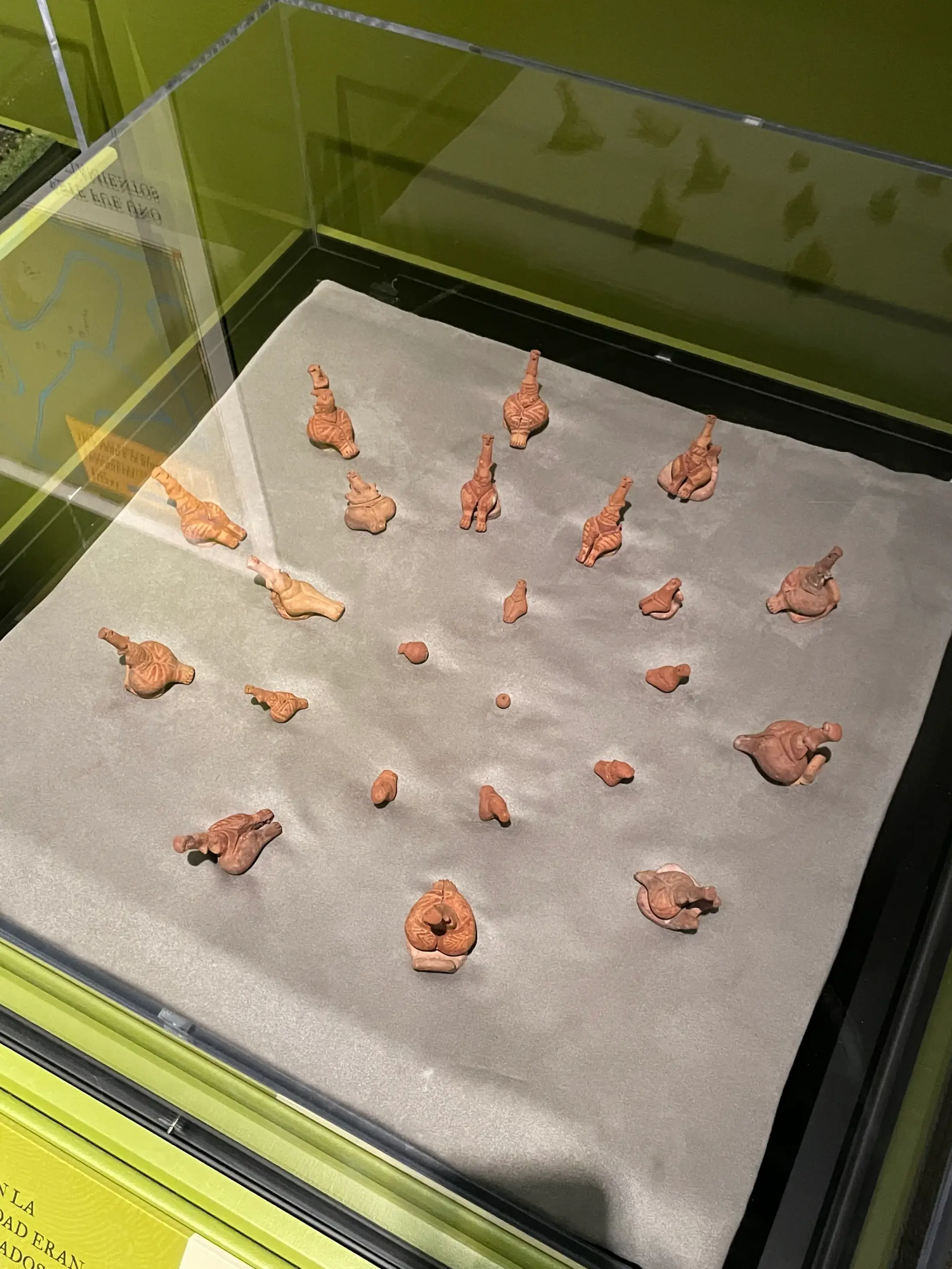 Ceramic figures, some of them seated, in a display case